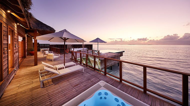 conrad maldives rangali island sunset water villa pool deck dusk